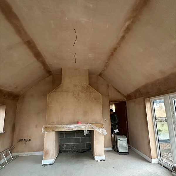 Plastering of walls and fireplace at Chester home